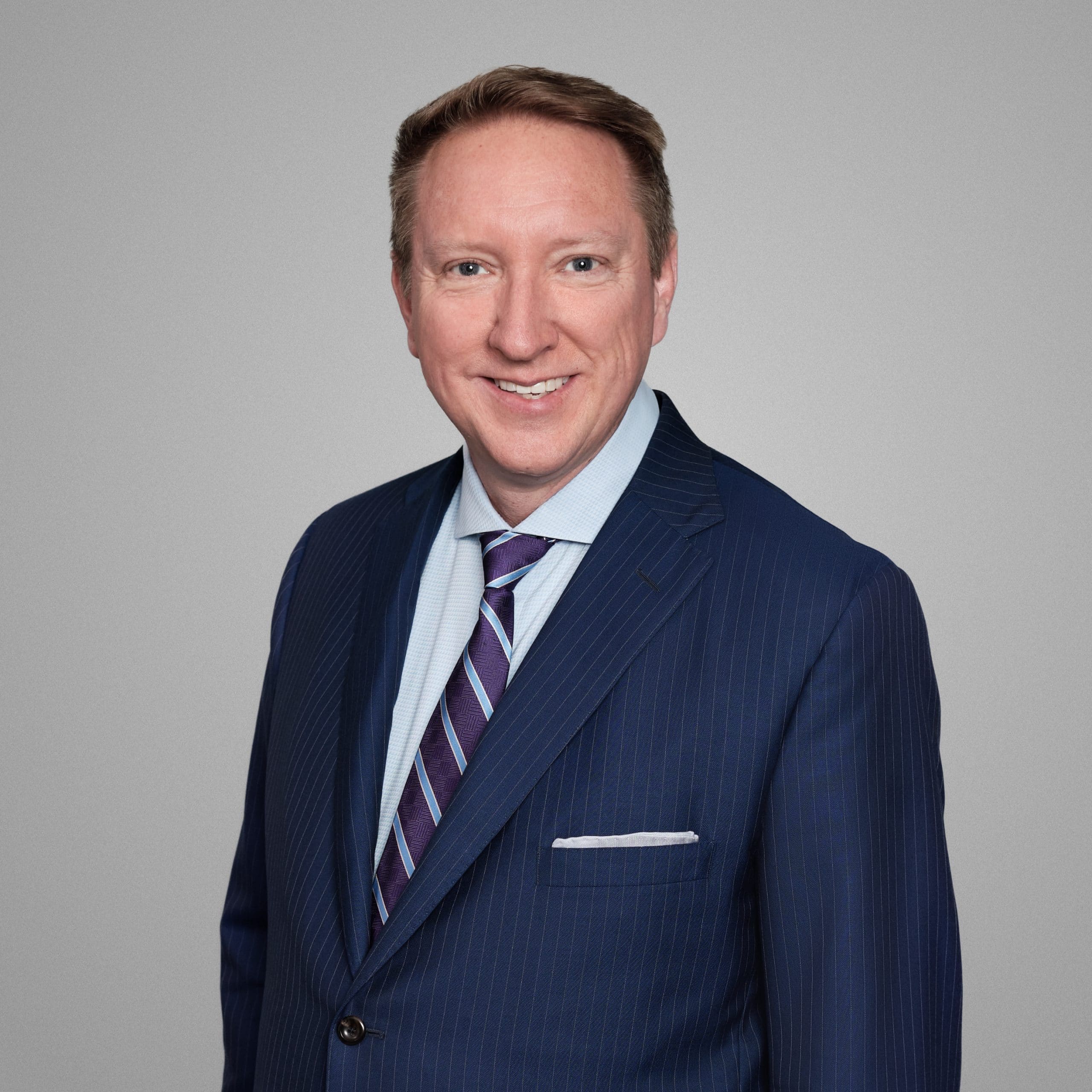 Headshot of Lee Hargitt in a blue suit.
